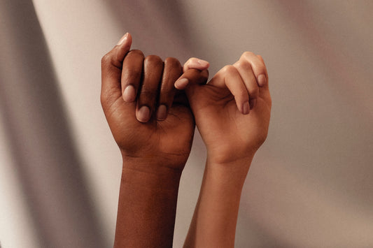 two hands with linked pinky fingers